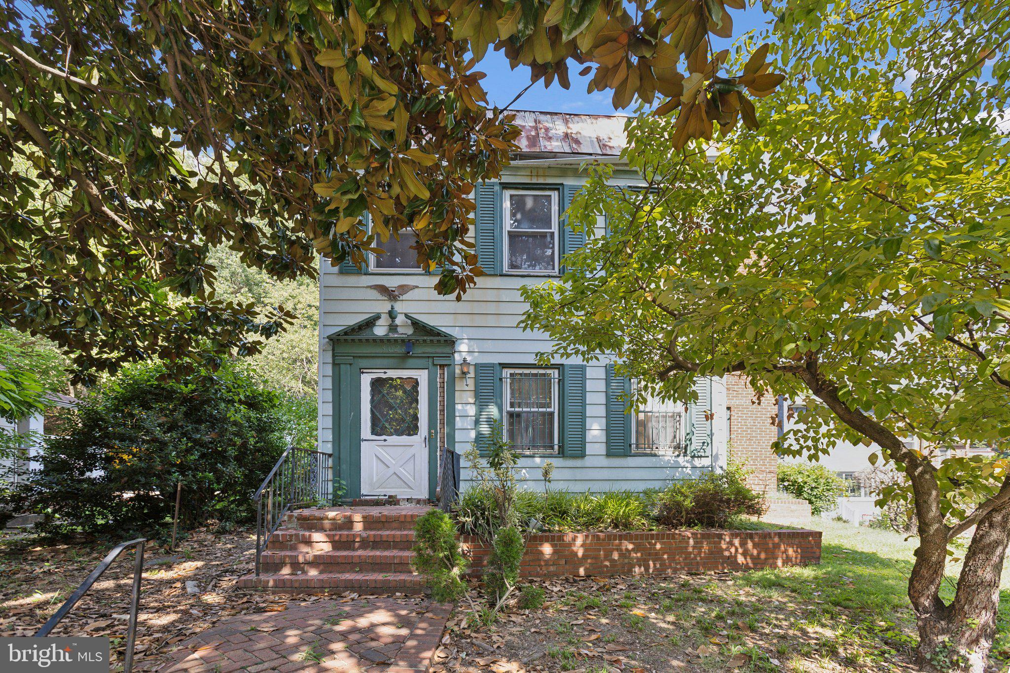 front view of a house with a tree