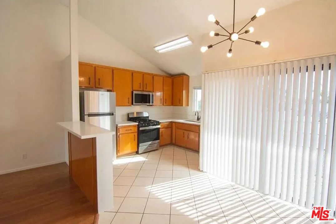 a kitchen with stainless steel appliances a refrigerator and a sink