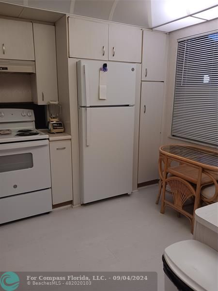 a white refrigerator freezer sitting in a kitchen