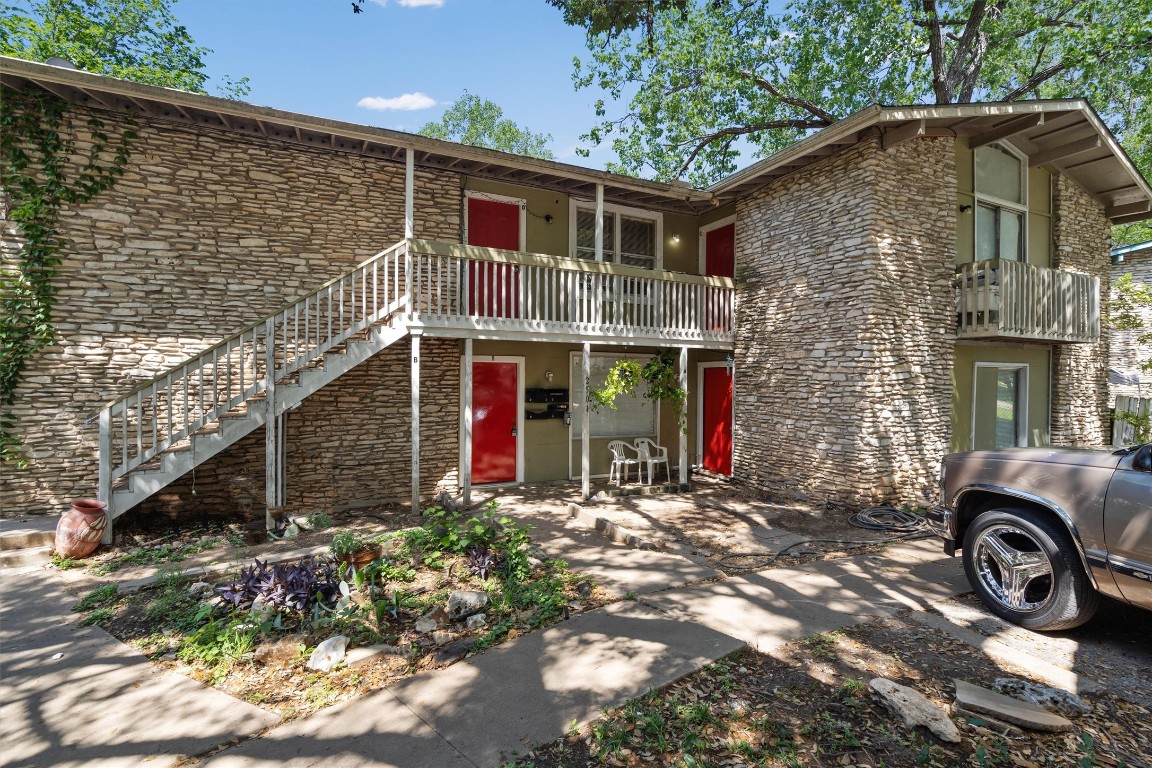 a view of a house with a yard and pathway