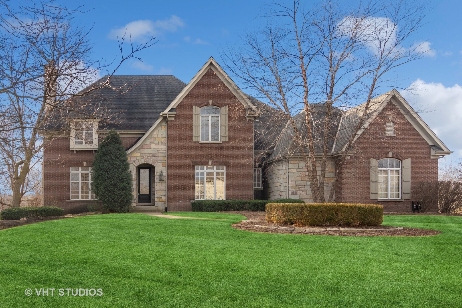 a front view of house with yard and green space