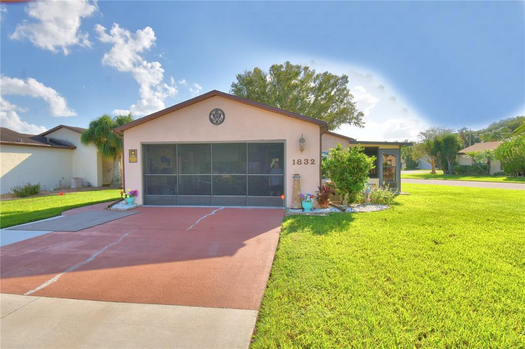 a front view of a house with a yard and garage