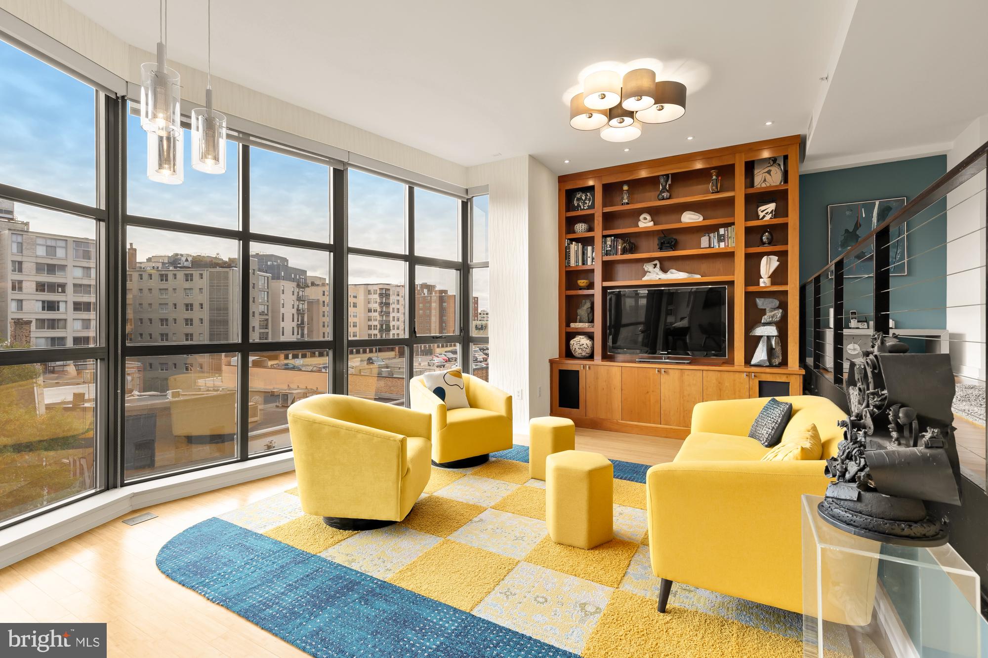 a living room with furniture and a floor to ceiling window