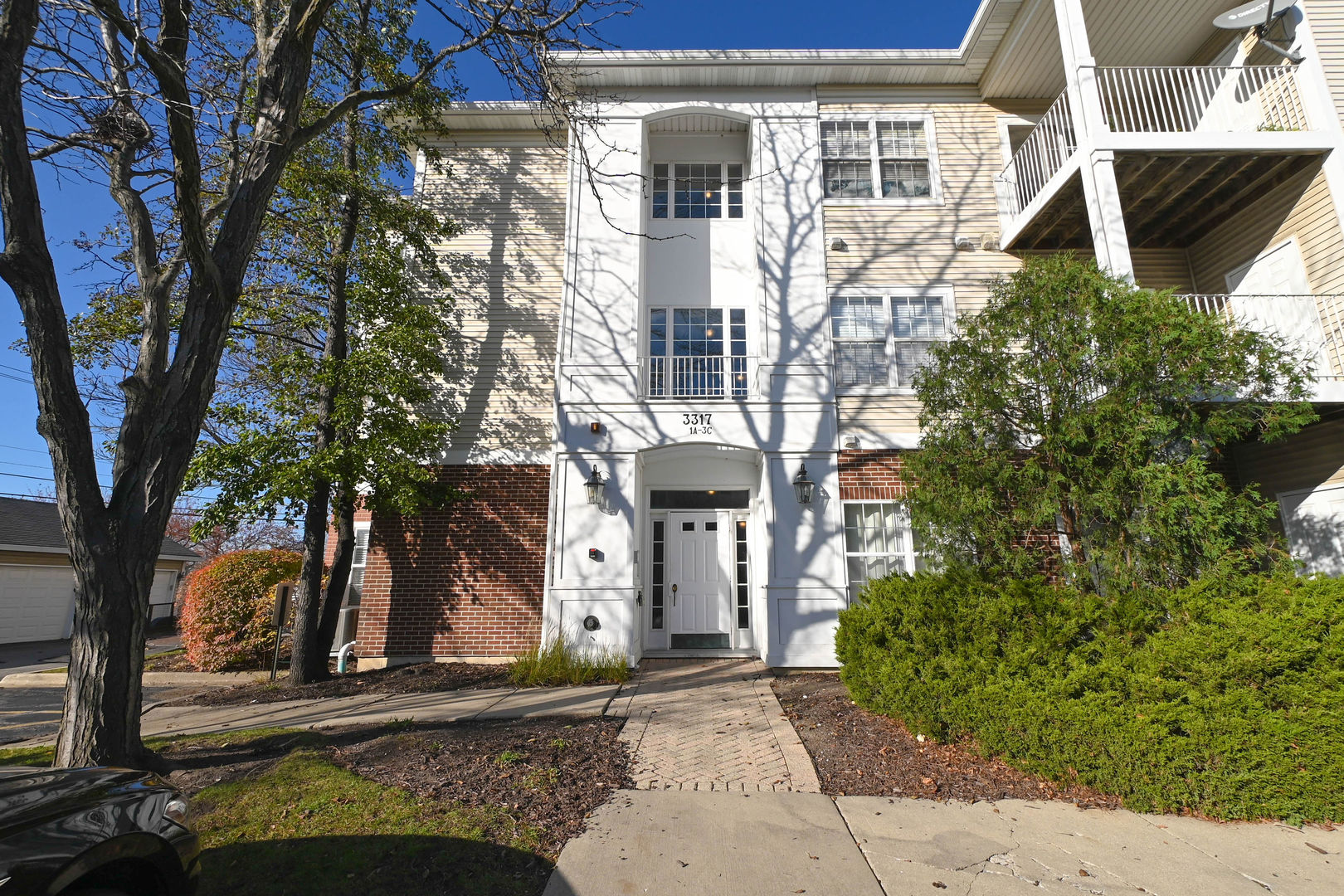 front view of a house with a tree