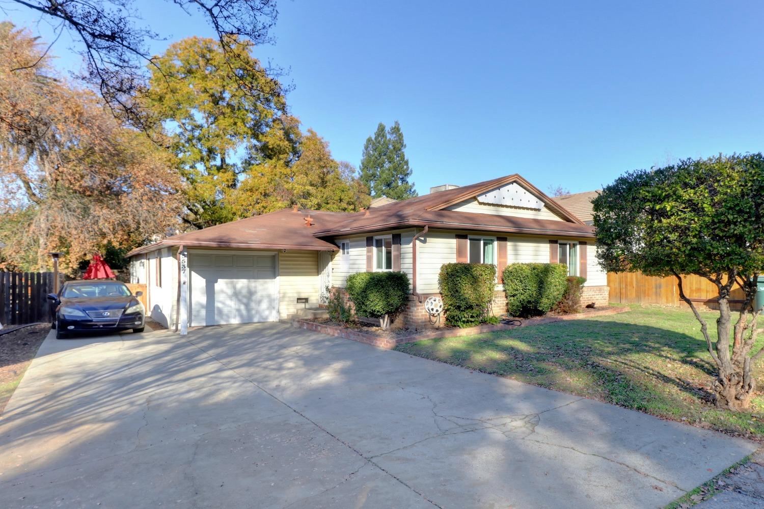 a front view of a house with a garden