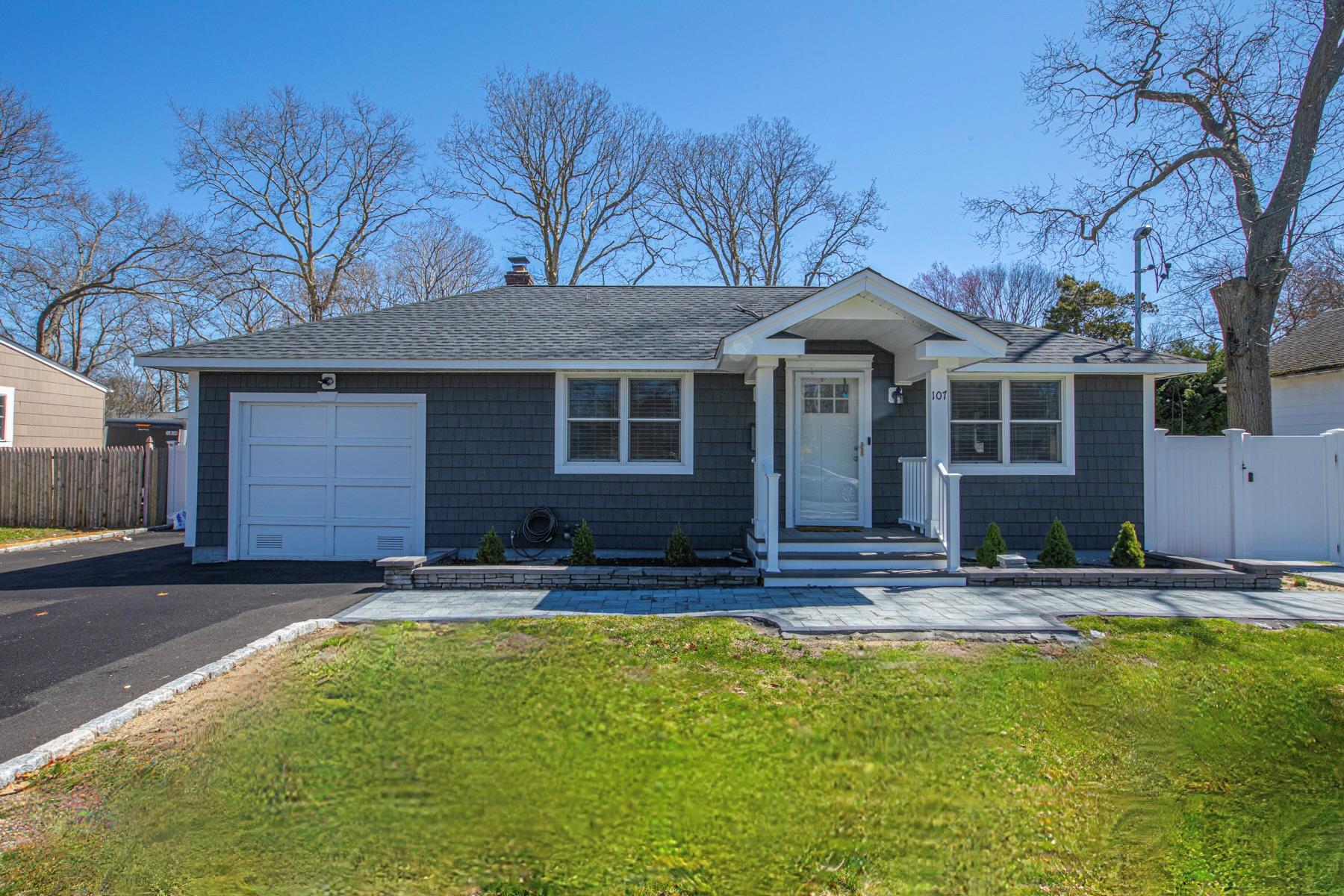 Ranch-style home with a front yard and a garage