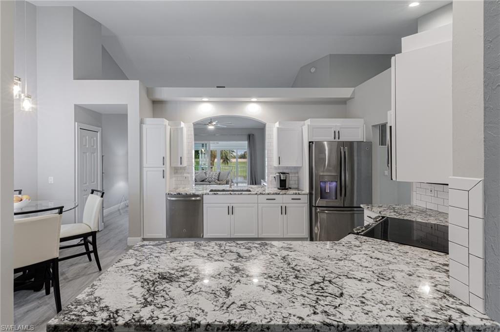 a kitchen with refrigerator and cabinets