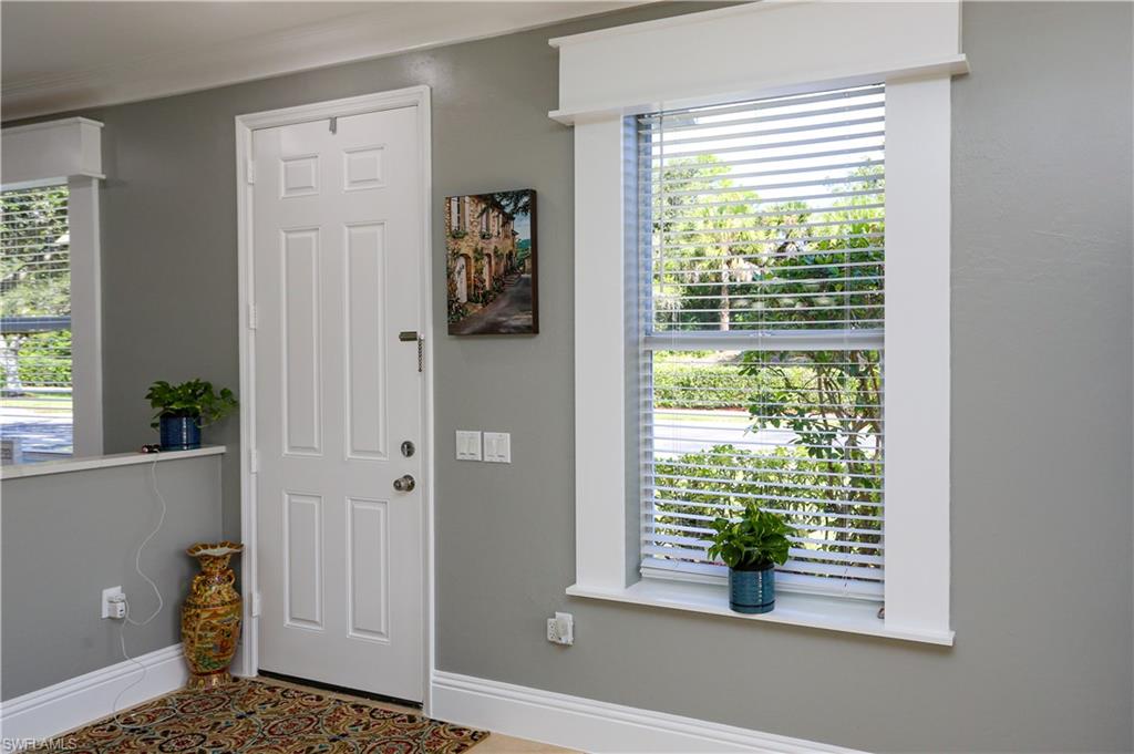 Entrance foyer featuring ornamental molding and tile patterned flooring