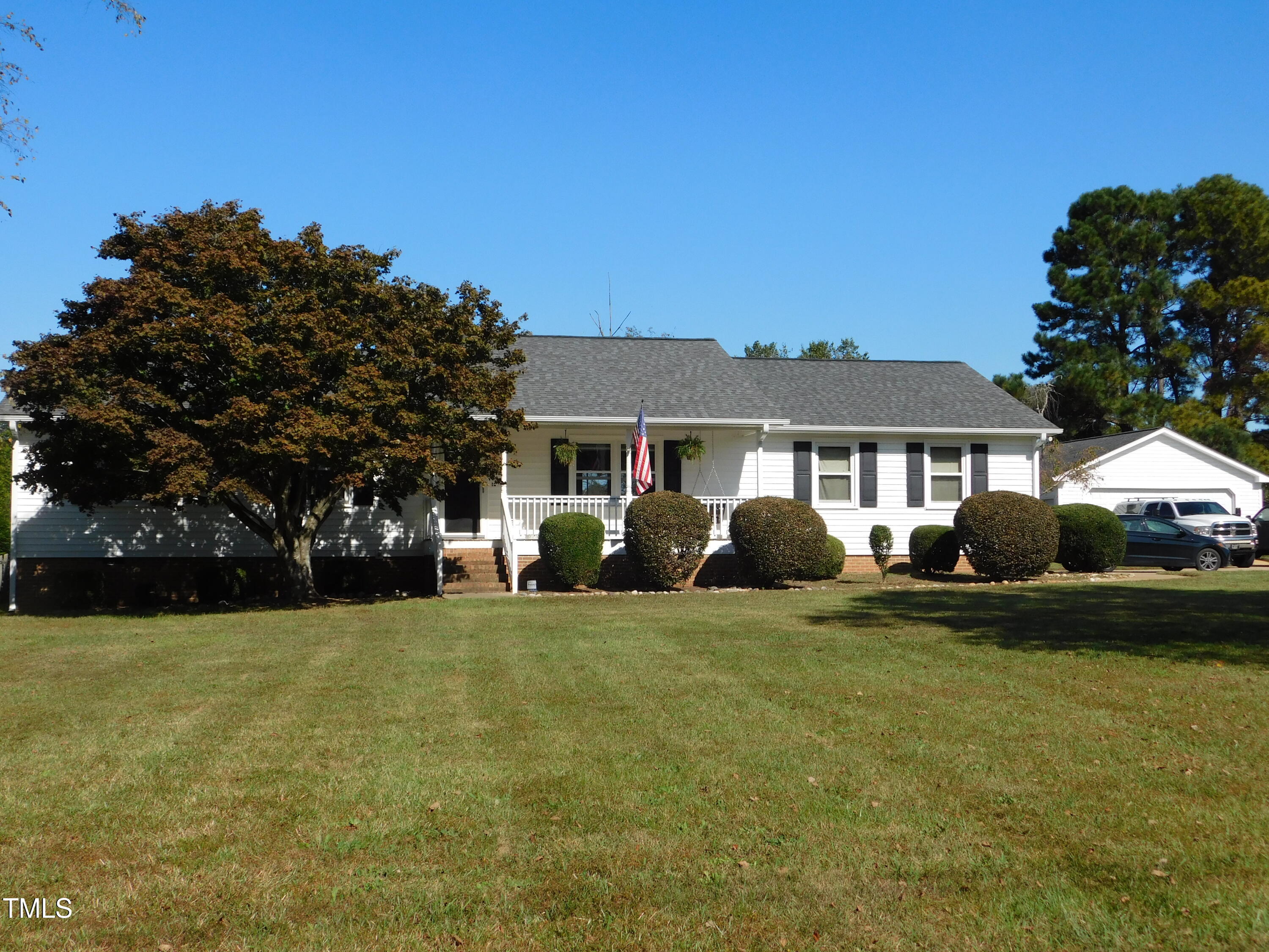 a view of a house with backyard and trees