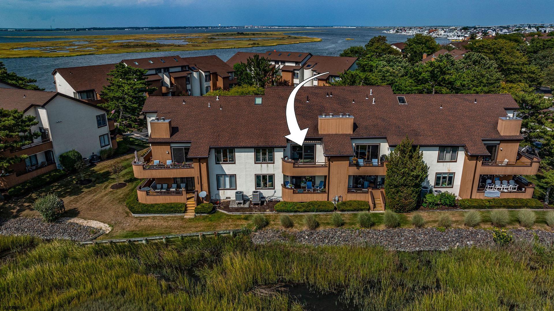 an aerial view of residential houses with outdoor space and swimming pool