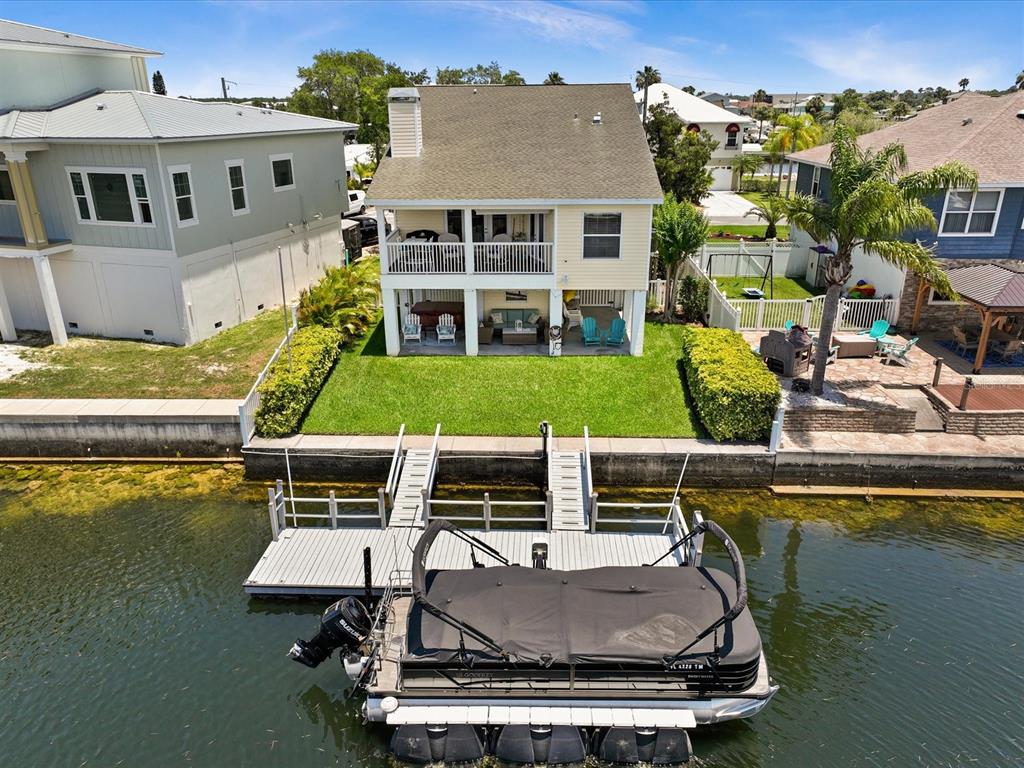 a view of a house with pool and chairs