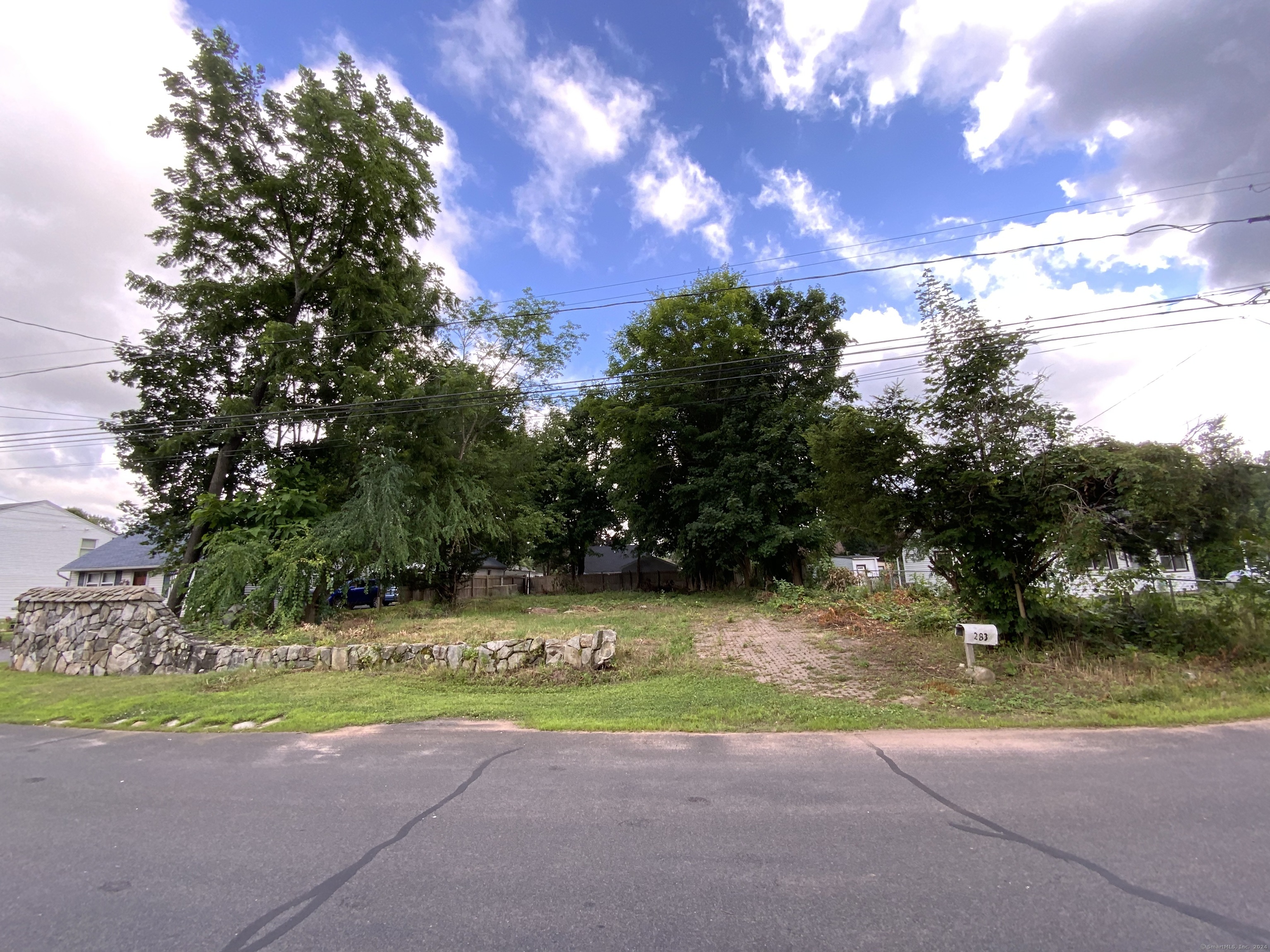 a view of a street with a yard