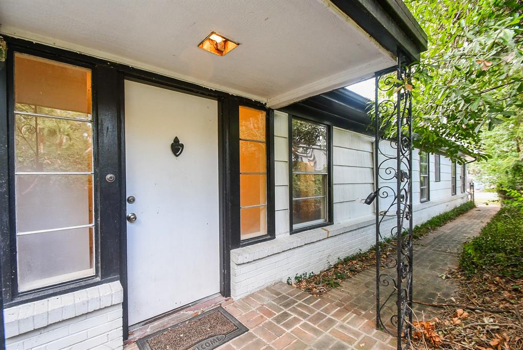 a view of a porch with a floor to ceiling window and wooden fence