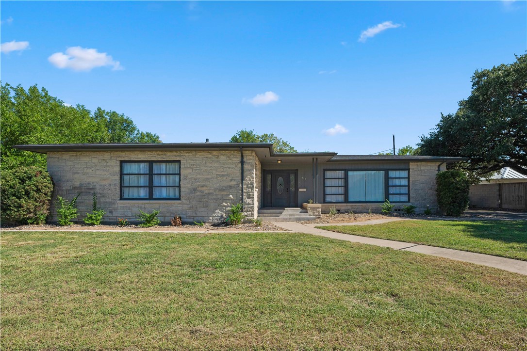 a front view of house with outdoor space and garden