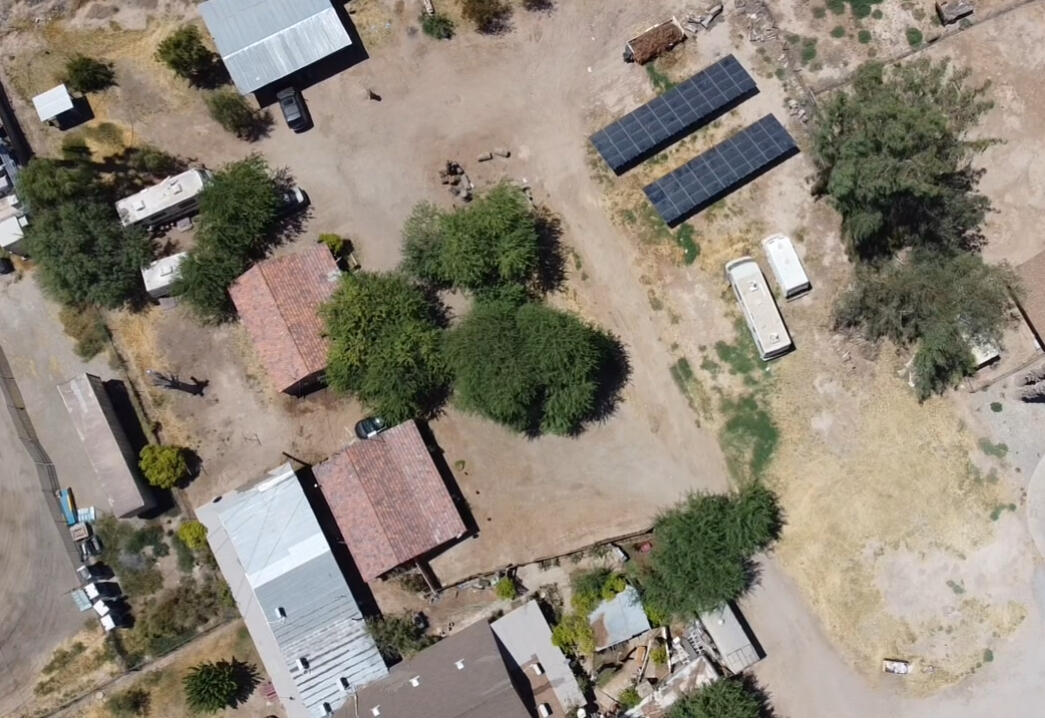 an aerial view of a house with a yard