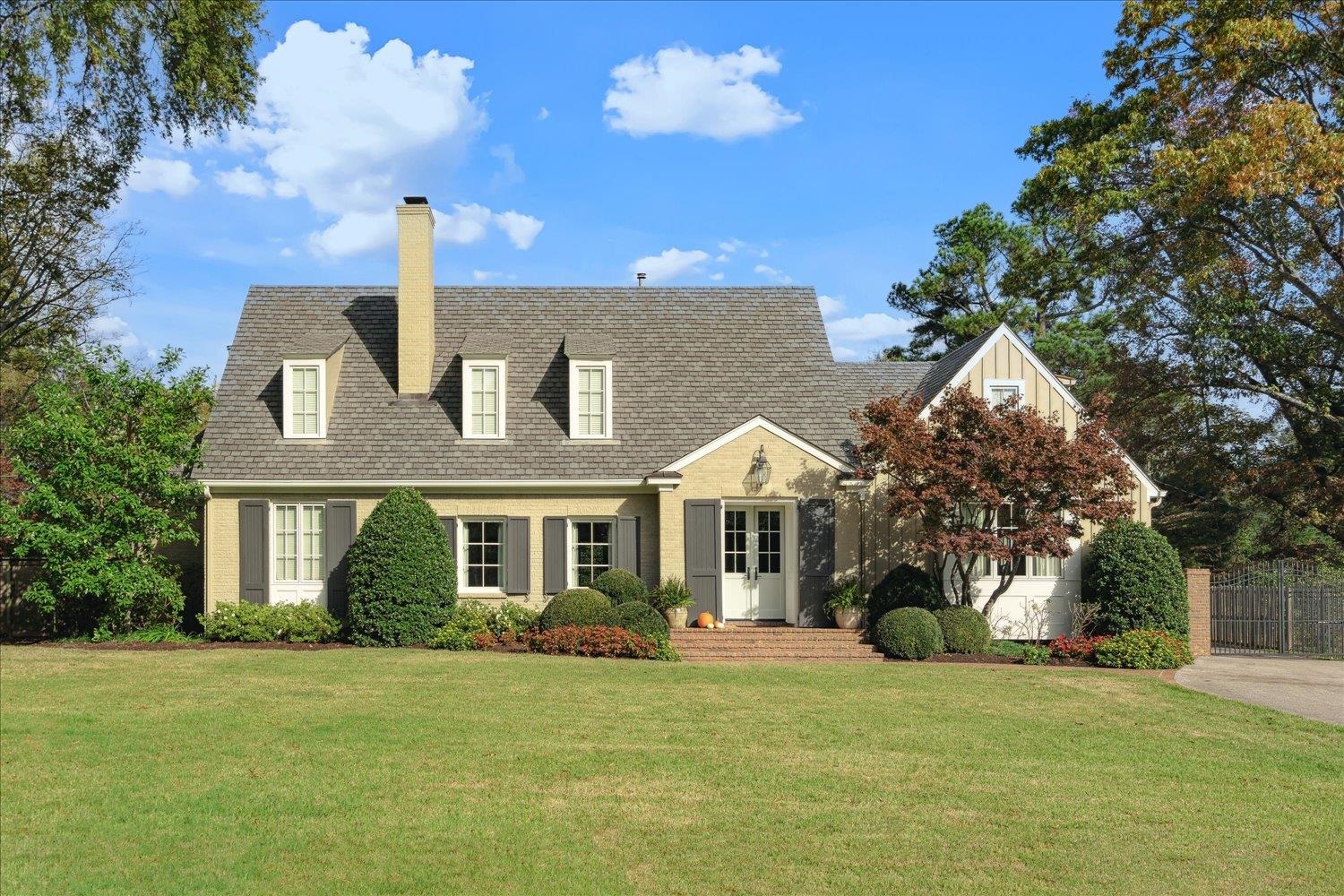 a front view of a house with a garden