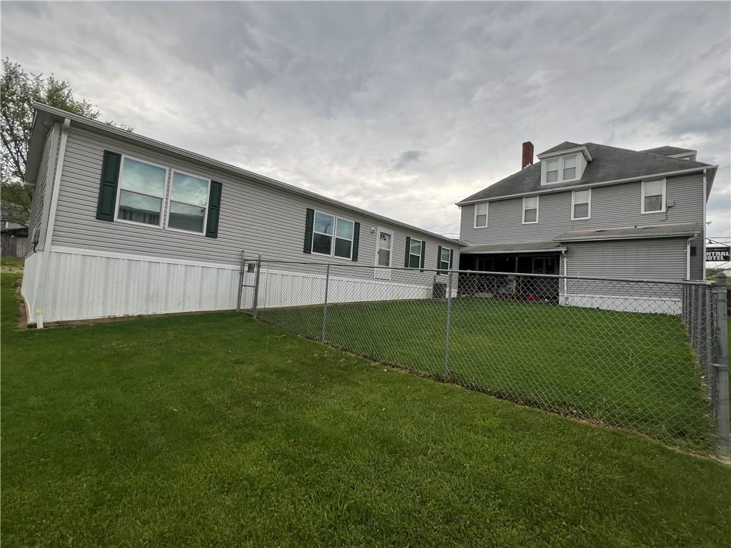 a view of house with backyard