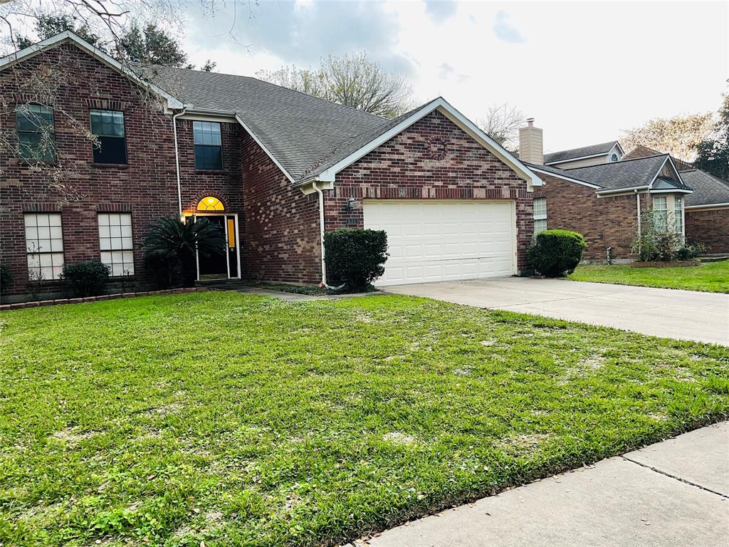 a view of a house with a yard and garage