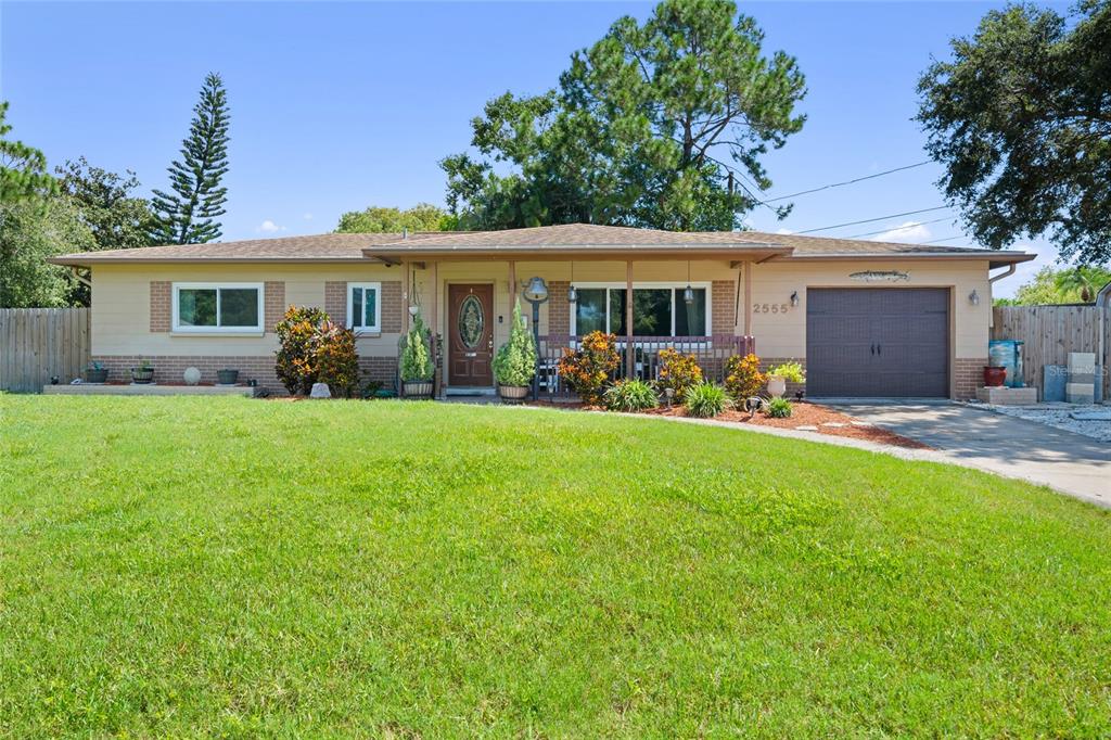 a front view of house with yard outdoor seating and green space