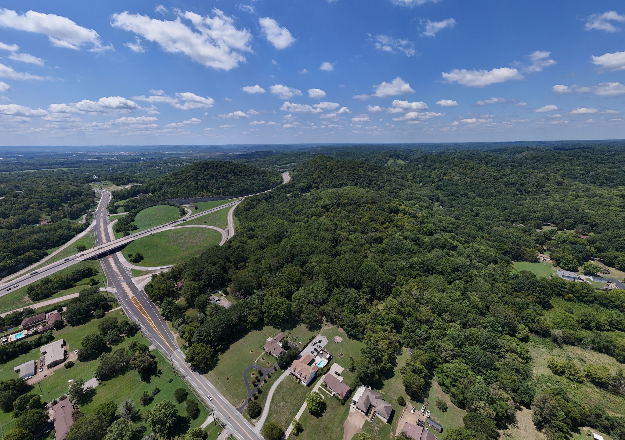 a view of a city with lush green forest