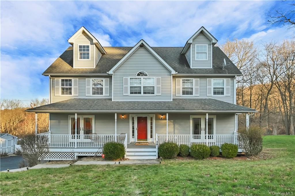 View of front of house with a porch and a front lawn