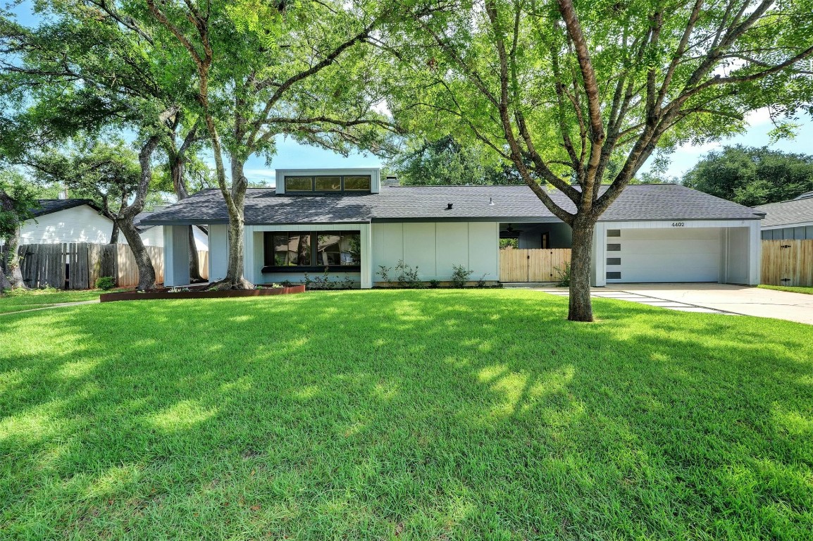 a front view of house with yard and green space