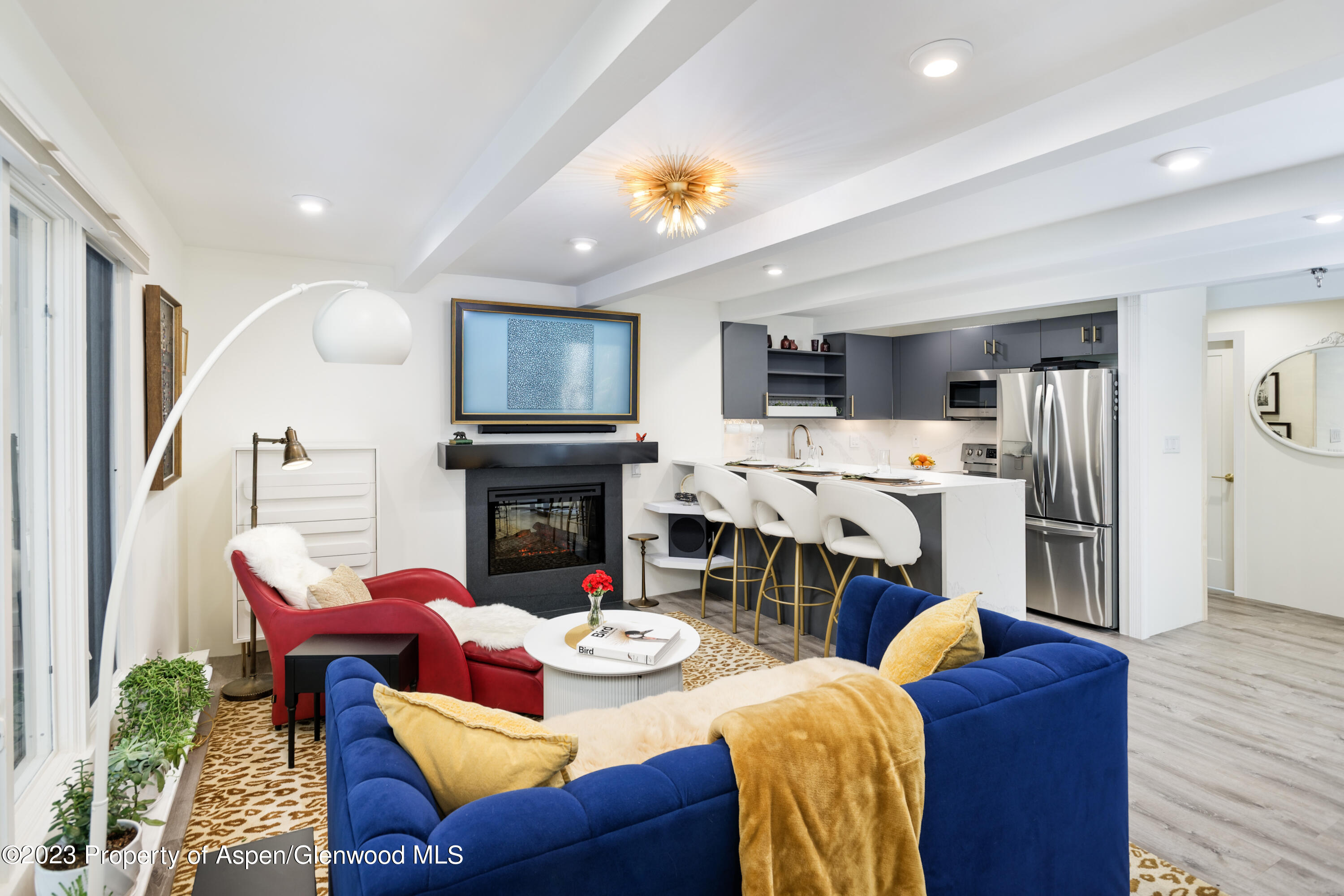 a living room with furniture a fireplace and a flat screen tv