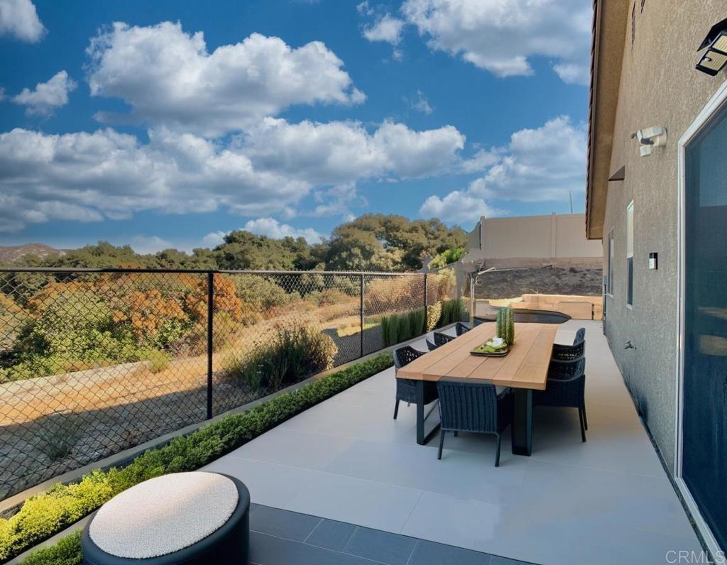 a view of a patio with lawn chairs next to a yard