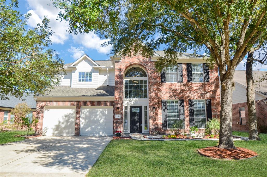 This stately 2-story brick treasure is located at 4111 Blue Forest Drive, Humble, TX, in the Atascocita community.