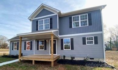 a brick house with a small yard and more windows