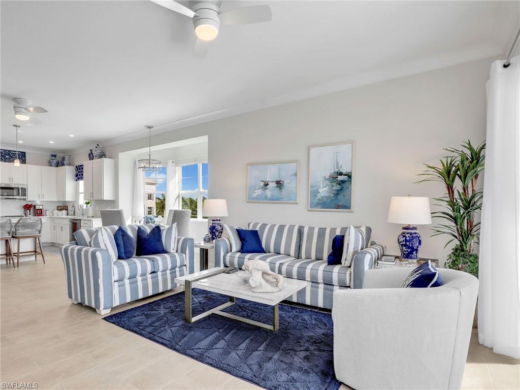 Living room featuring light hardwood / wood-style flooring, ceiling fan, and crown molding