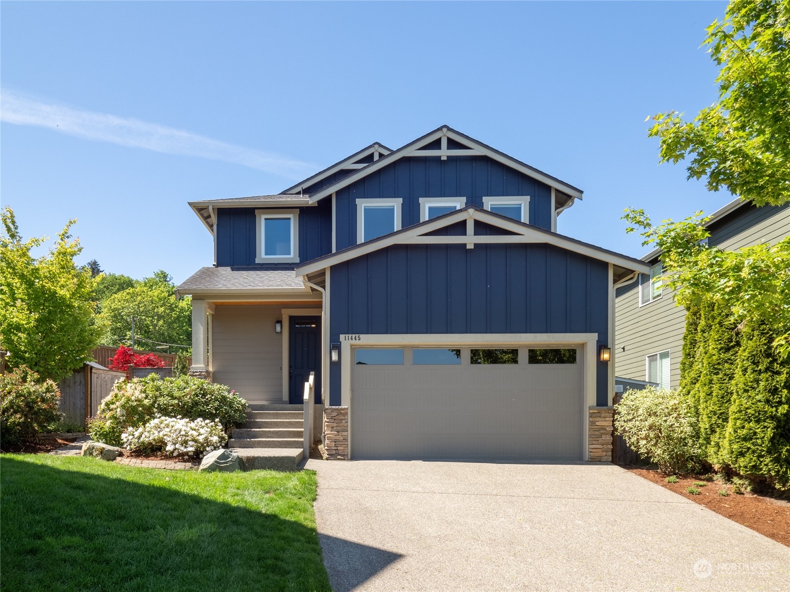 a front view of a house with a yard and garage