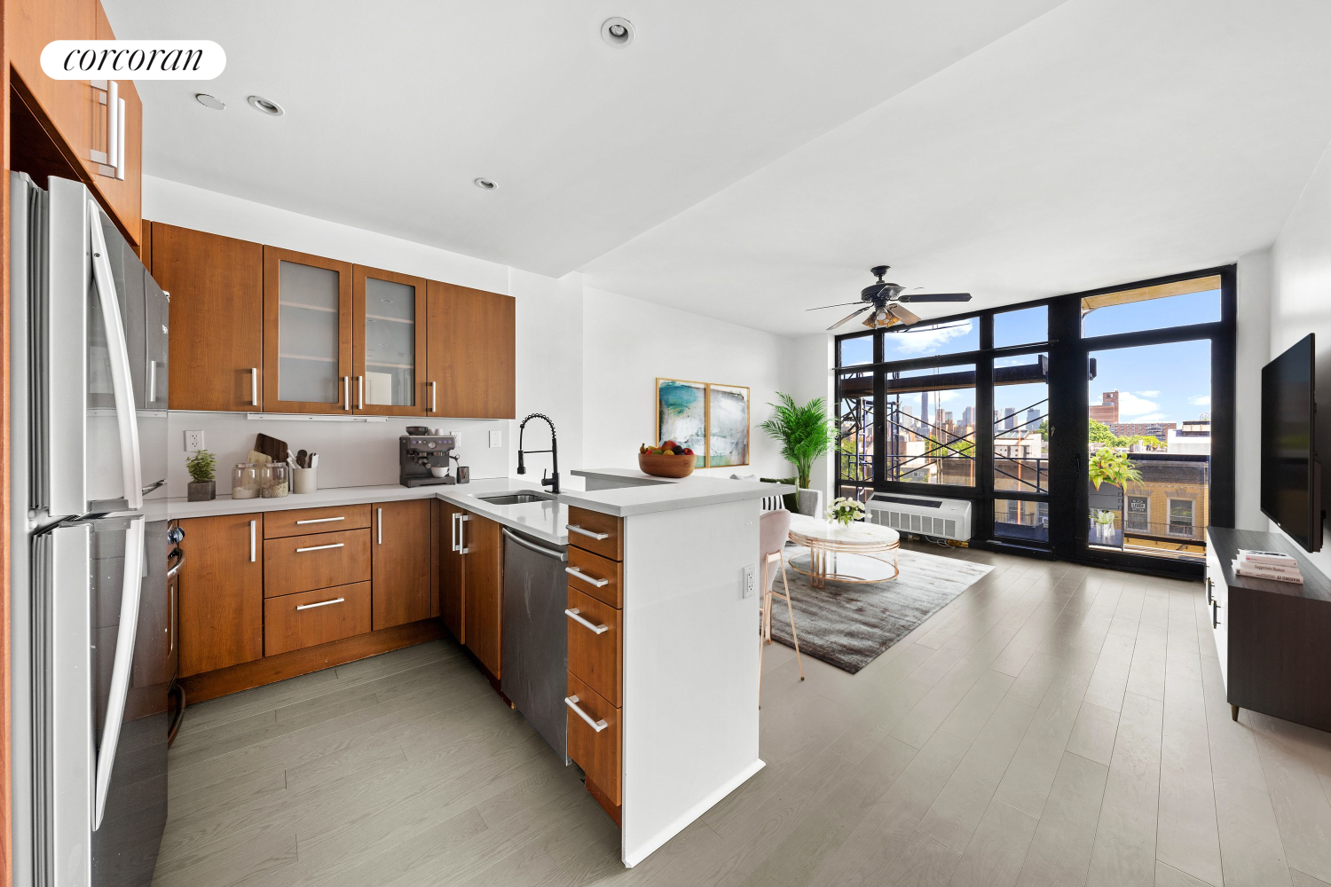 a kitchen that has a lot of cabinets in it and wooden floors