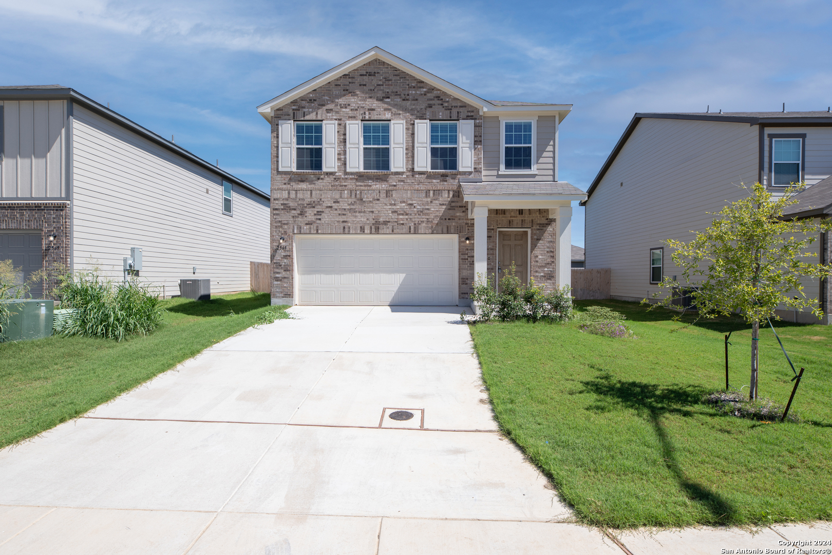 a front view of a house with a yard