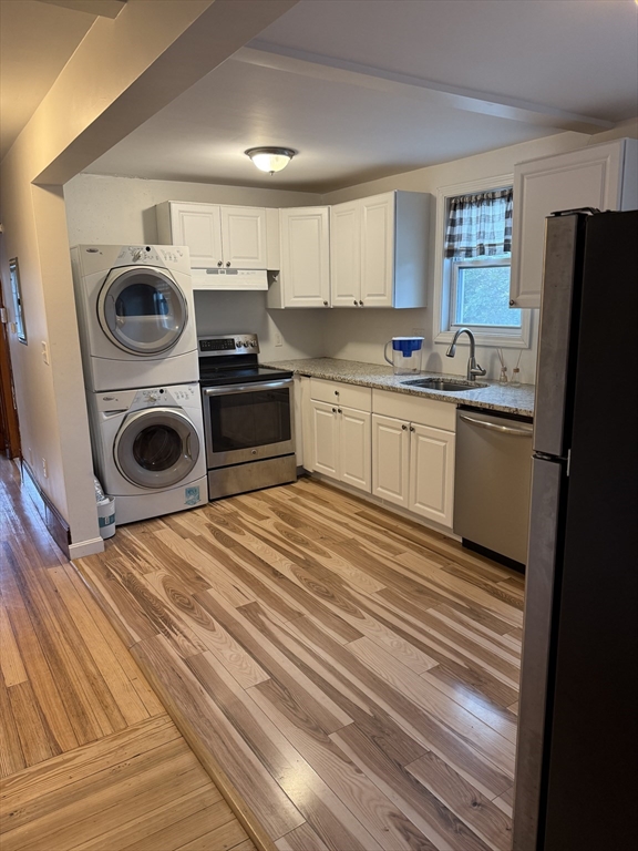 a kitchen with a refrigerator and cabinets