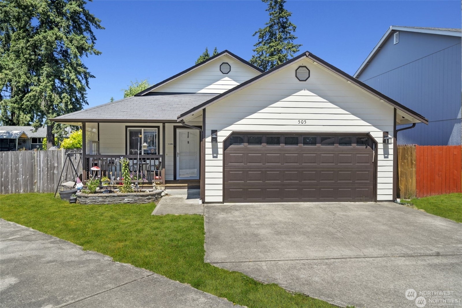 a front view of a house with a yard and outdoor seating