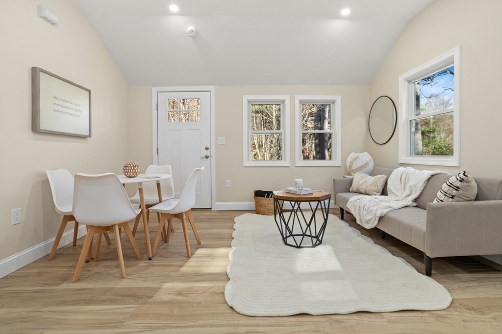 a living room with furniture a table and a large window