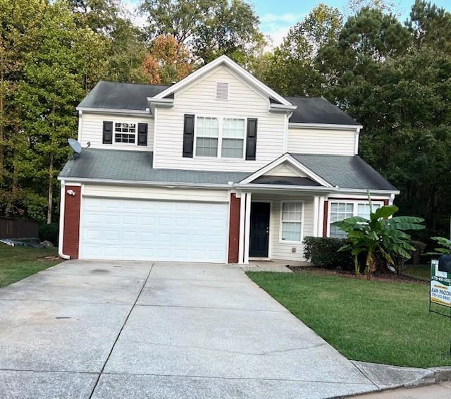 a front view of a house with a yard and trees