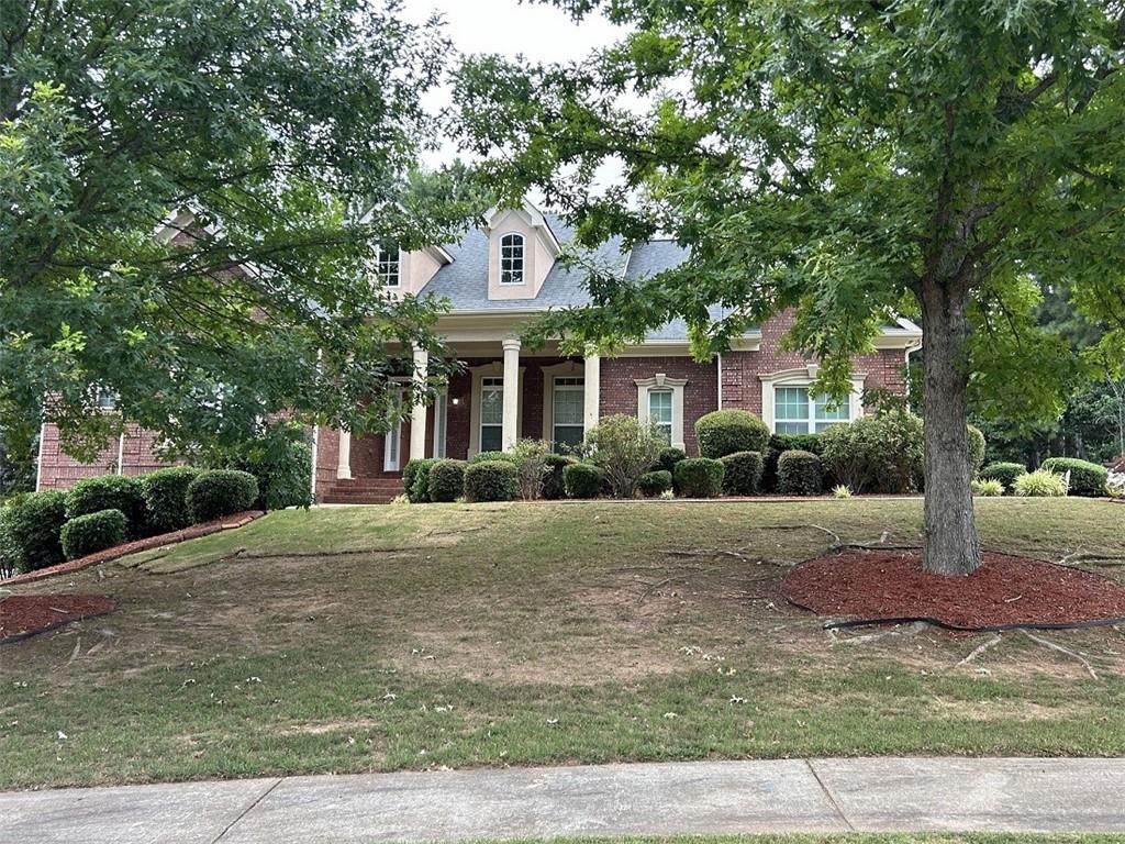 a front view of a house with a yard