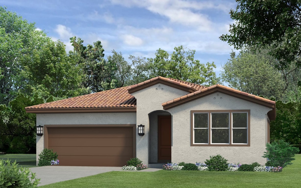 a front view of a house with a garden and yard