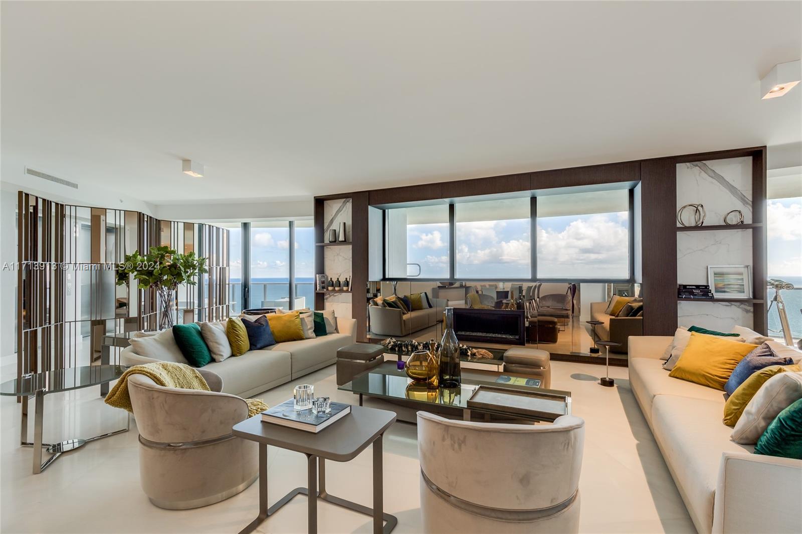 a living room with furniture and floor to ceiling windows