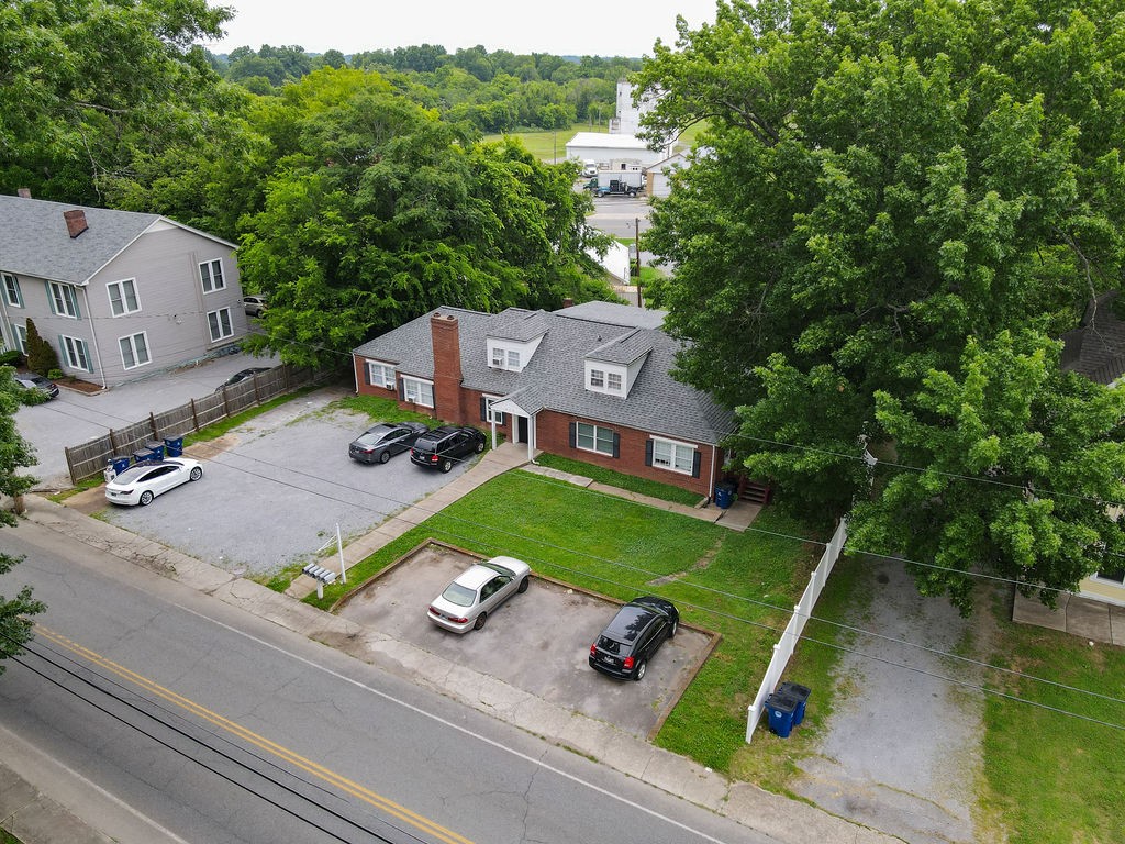 an aerial view of a house with a big yard