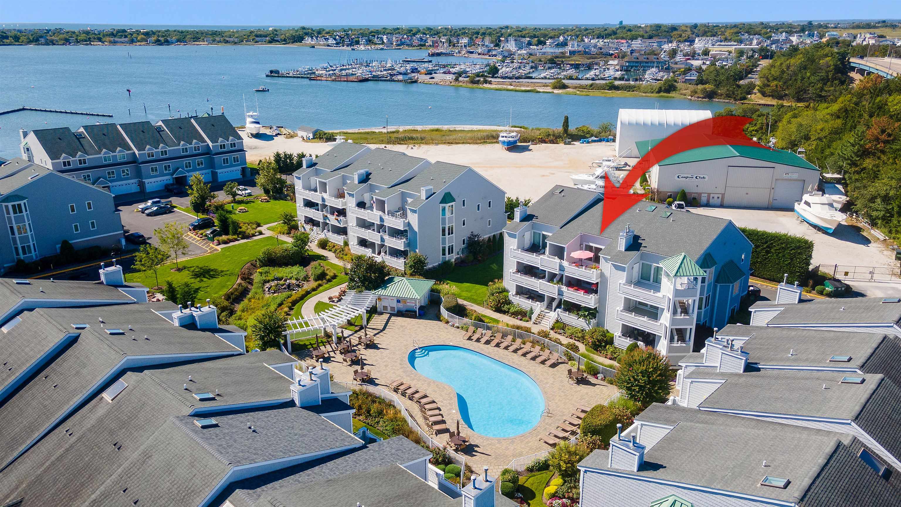 an aerial view of a house with a swimming pool outdoor seating and yard