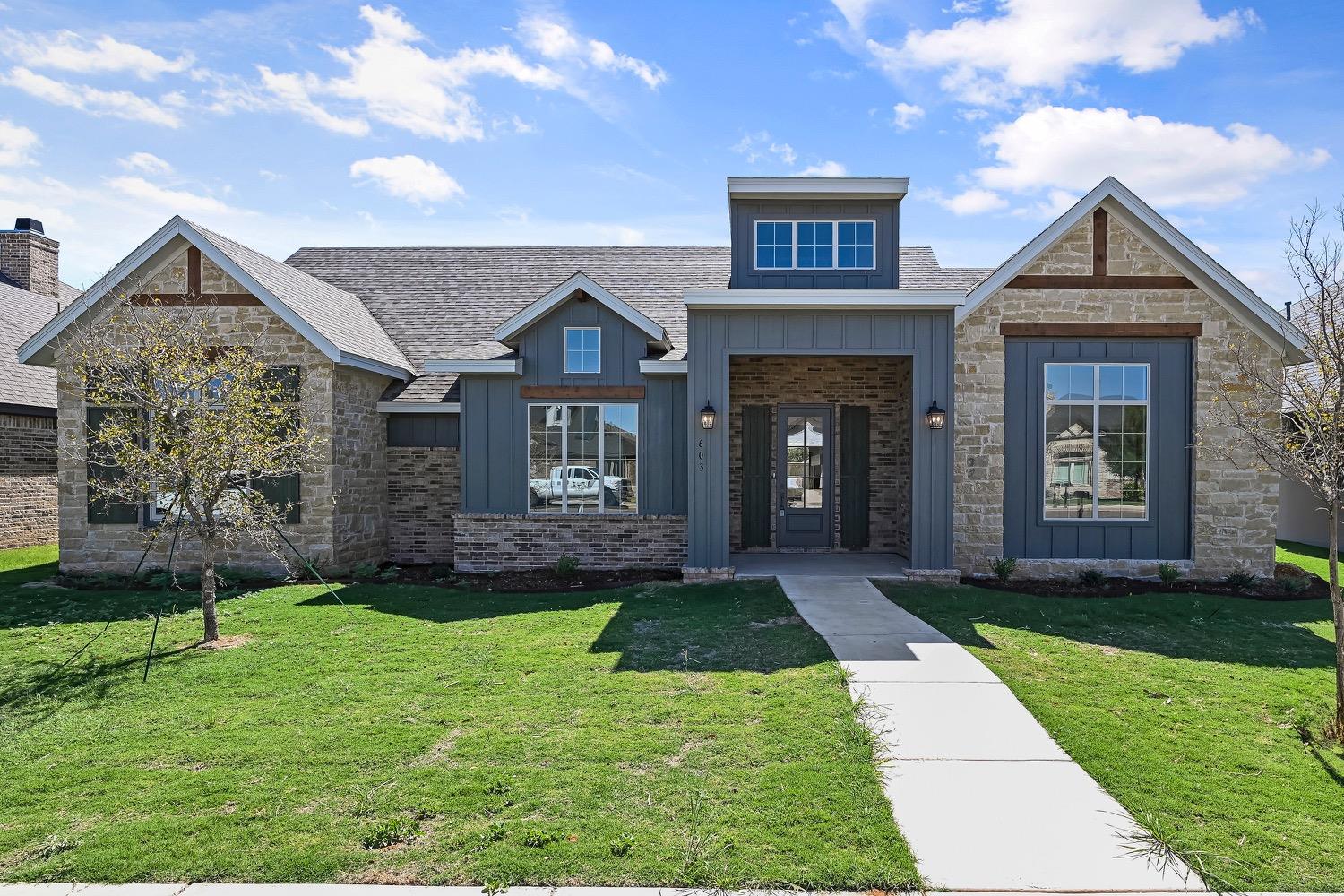 a view of a brick house with a yard