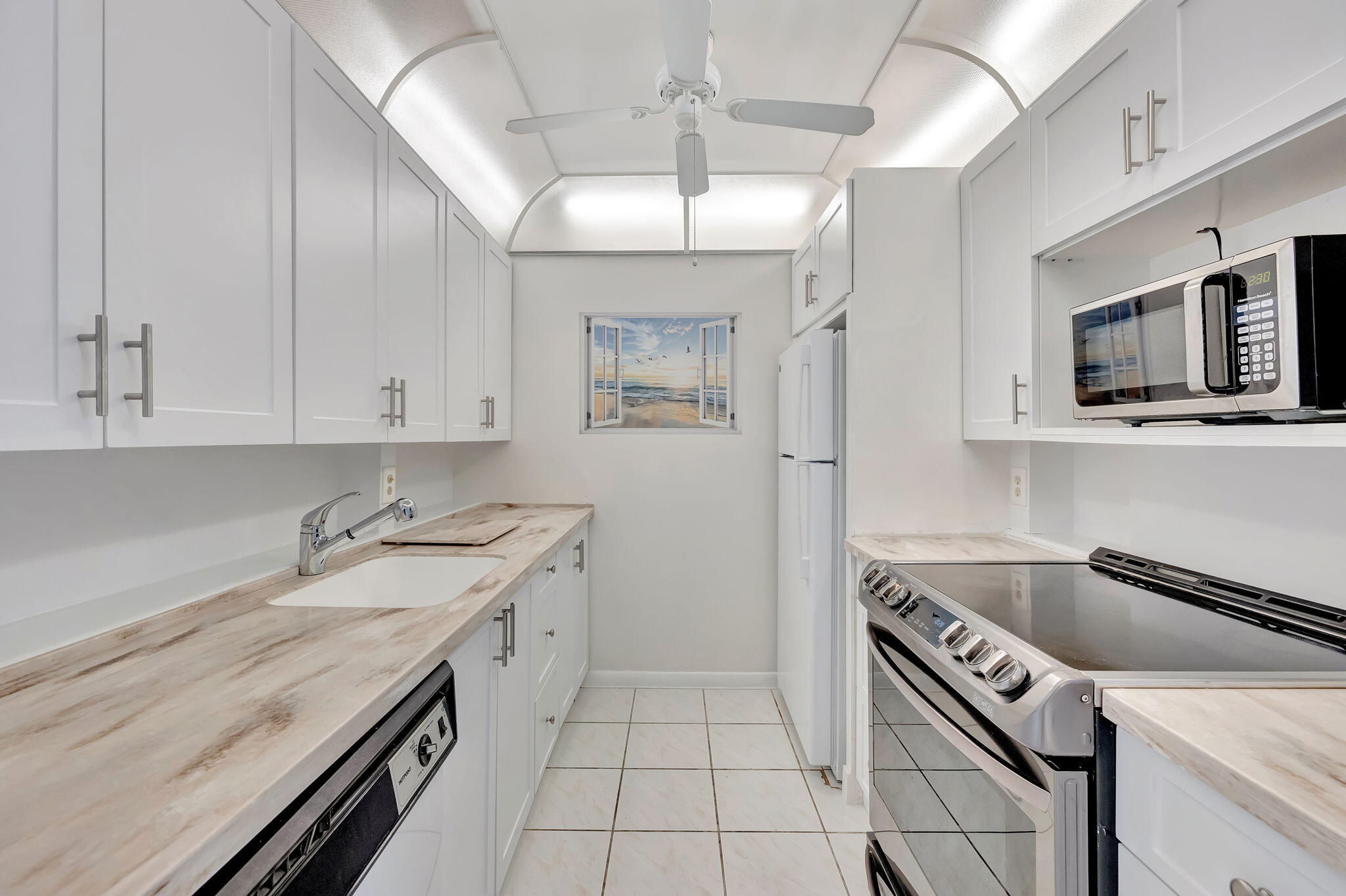 a kitchen that has a lot of cabinets in it