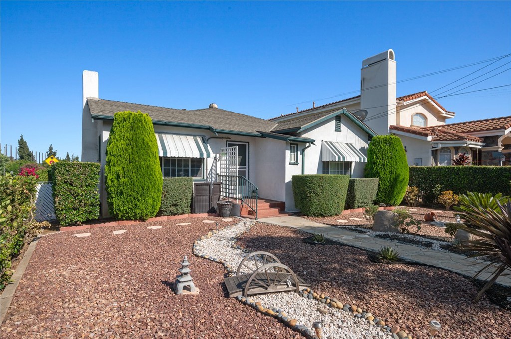 a front view of a house with garden