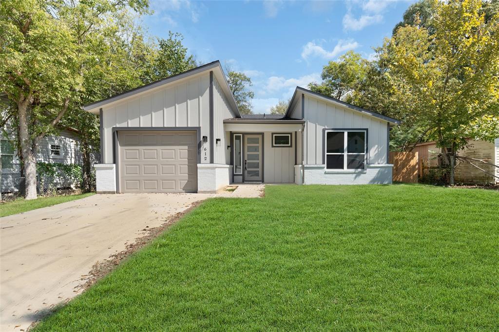 a front view of house with yard and green space