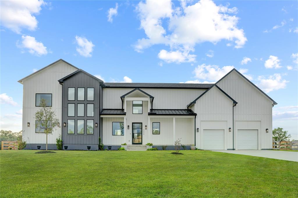 a view of a big house with a big yard and large trees