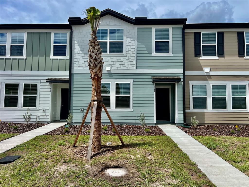 a front view of a house with a yard