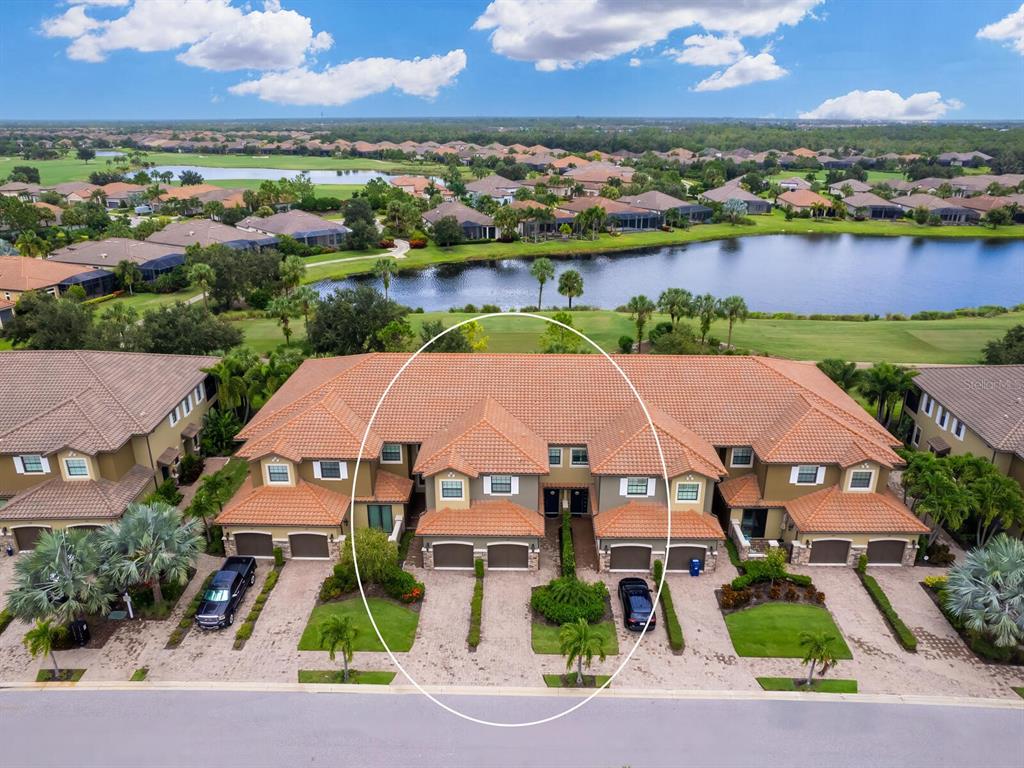 an aerial view of house with yard and ocean view